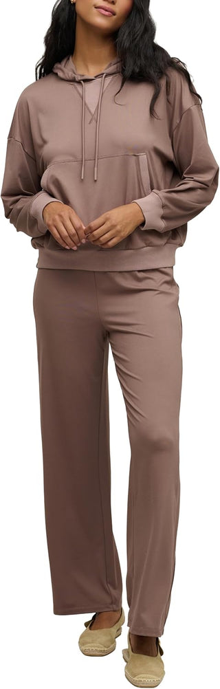 Woman wearing a brown tracksuit on a white background