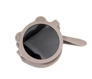 Beige sunglasses with a clip on a white background