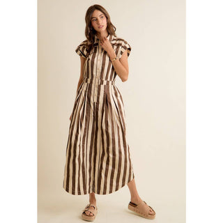 Woman wearing a brown and beige striped dress on a beige background