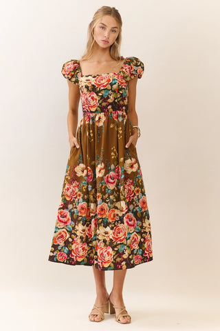 Woman wearing a floral dress on a plain background