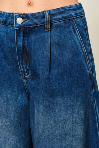 Close-up of blue jeans with a neutral background