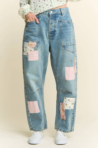 Blue jeans with patchwork design on a beige background