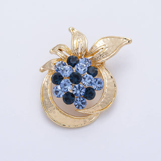 Gold pendant with blue gemstones on a white background