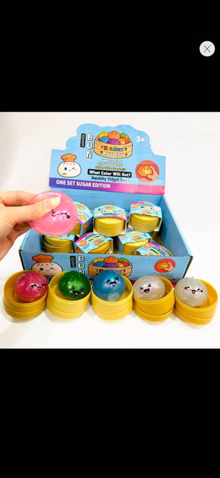 Colorful rubber duck toys with packaging on a white background