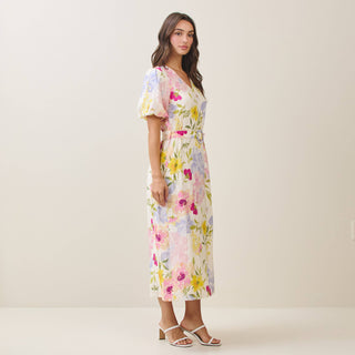 Woman wearing a floral dress against a plain background