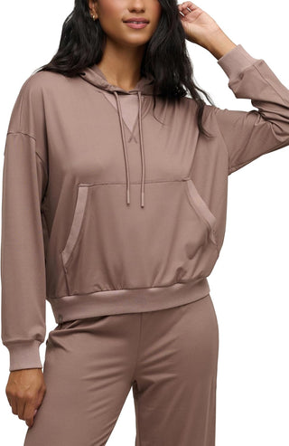 Person wearing a brown hoodie and pants on a white background