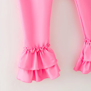 Pink ruffled pants on a light pink background