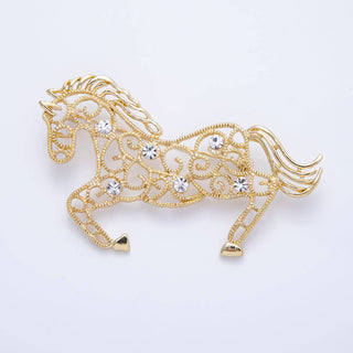 Gold horse-shaped brooch with crystal embellishments on a light gray background