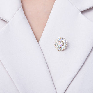 Close-up of a lapel pin on a light-colored suit jacket