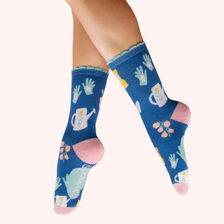Colorful socks with gardening-themed design on a white background