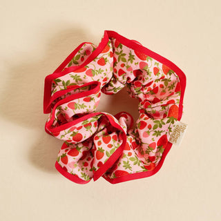 Scrunchie with strawberry pattern on a beige background