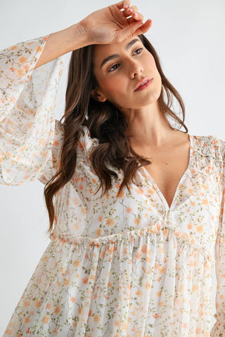 Woman wearing a floral dress against a white background