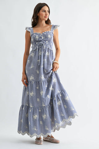 Woman wearing a blue floral dress on a white background
