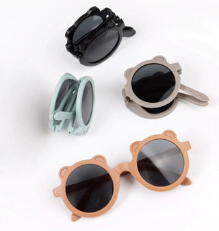 Set of four pairs of sunglasses with unique designs on a white background