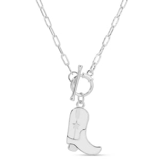 Silver cowboy boot pendant on a chain against a white background