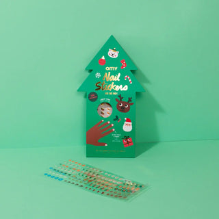 Green tree-shaped box of nail stickers with a clear sheet of stickers on a green background