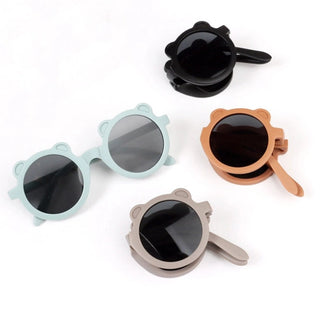 Four pairs of sunglasses with different colored frames on a white background