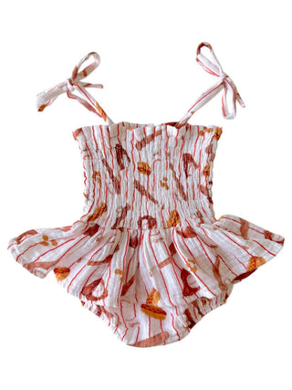 Baby romper with red and orange pattern on a white background