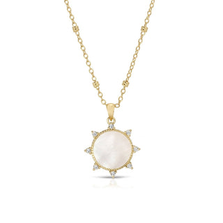 Gold necklace with a pendant featuring a white stone on a white background
