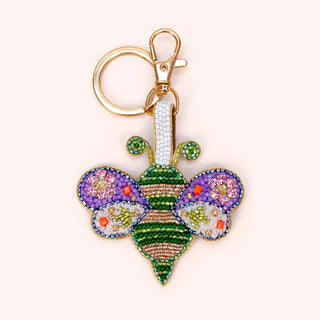 Colorful butterfly-shaped keychain with rhinestone details on a white background