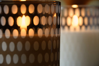 Candle in a polka dot holder with blurred background
