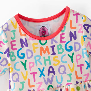 Children's outfit with colorful alphabet pattern on a white background