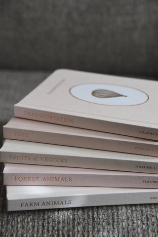 Stack of books with titles on a textured surface