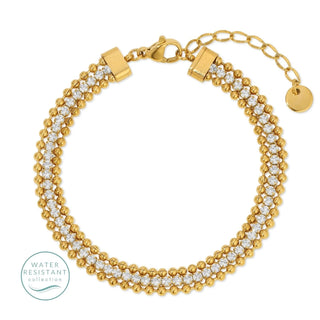 Gold bracelet with clear stones on a white background