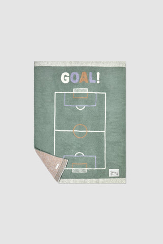 Blanket with soccer field design and 'GOAL!' text on a light gray background