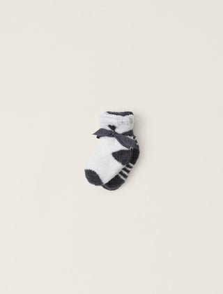 Pair of black and white checkered socks on a beige background