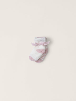 Baby sock with a bow on a light pink background
