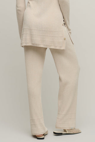 Beige suit with matching pants on a plain background