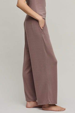 Brown wide-leg pants worn by a person on a plain background