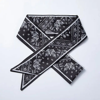 Black bandana with white paisley pattern on a light gray background