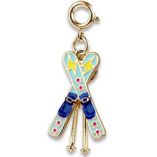Gold charm with blue and gold skis on a white background
