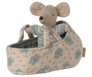 Stuffed mouse toy in a floral-patterned crib on a white background