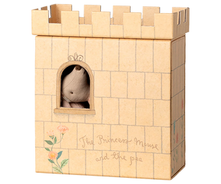 Wooden castle toy with a small plush toy inside, on a white background