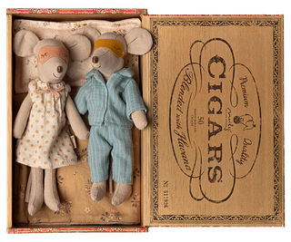 Two toy mice, a girl in a dress and a boy in overalls, inside an open cigar box with decorative text.
