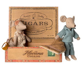 Two toy mice in a wooden Havaina Cigars box on a white background