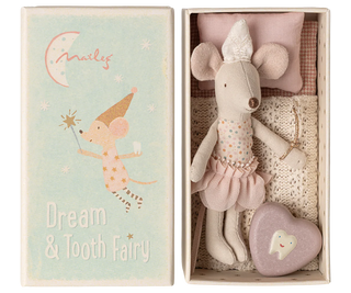 Stuffed mouse toy with a heart-shaped pillow in a box, next to a decorative card with text and illustrations.