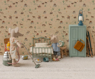 Children's room with toy furniture and decor, featuring a patterned wall.