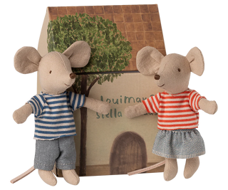 Two plush mouse toys with a small house and tree in the background