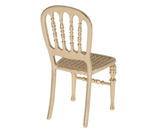 Beige chair with a woven seat on a white background