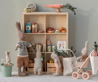 Children's room with toy rabbits, a bookshelf, and decorative items.