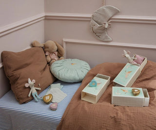 Children's bedroom with toys and decorative items on a bed