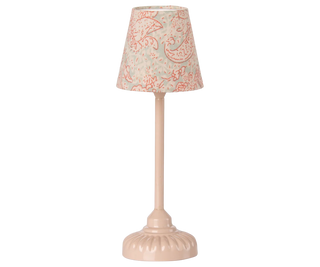 Small table lamp with a decorative pink and white patterned shade on a white background