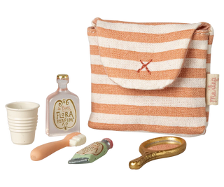 miniature striped bag with miniature toothbrush, toothpaste and hand mirror