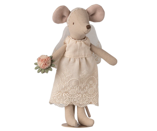 Stuffed mouse toy in a dress holding flowers on a white background
