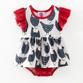 Children's outfit with chicken pattern and red ruffled sleeves on a white background