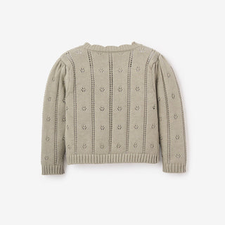 Light brown knitted sweater with subtle pattern on a white background